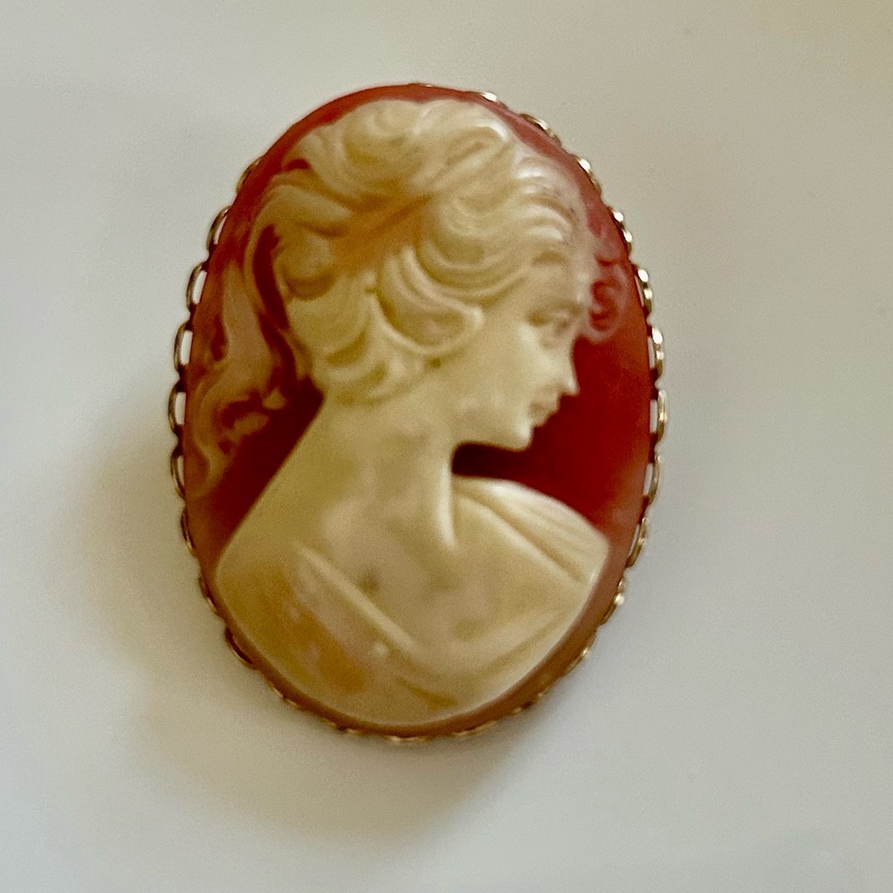 Mid Century Cameo Brooch in Cream on Coral Background